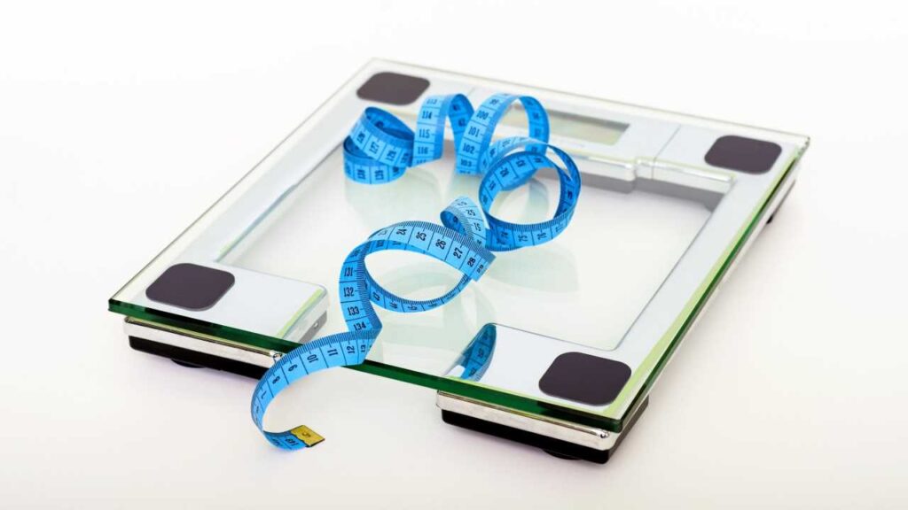 Blue Tape Measure on Clear Glass Square Weighing Scale